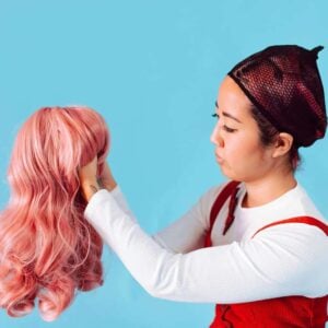 Styling cosplay wigs - woman holding a pink wig