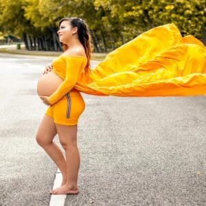Woman wearing a pregnant cosplay of Kill Bill