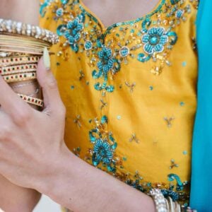 Woman wearing costume jewelry in a bright yellow dress