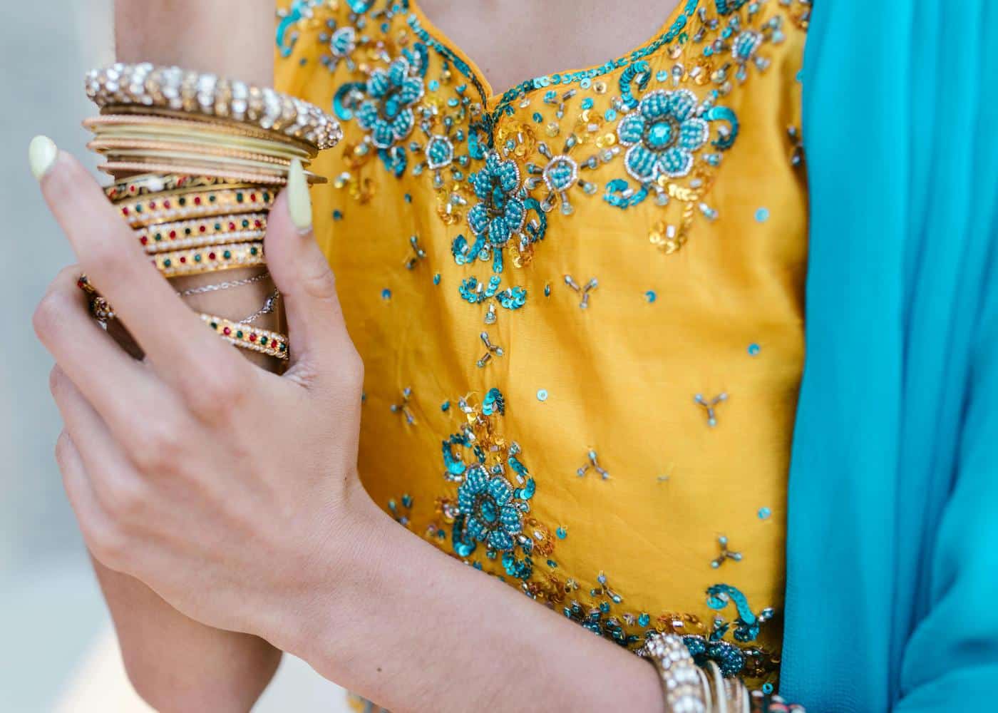 Woman wearing costume jewelry in a bright yellow dress