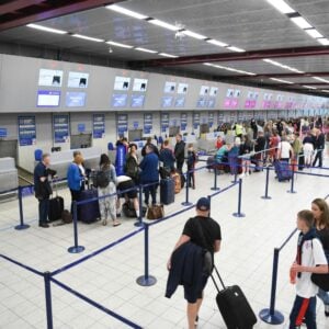 Fancy dress at airport: Image of a busy check-in