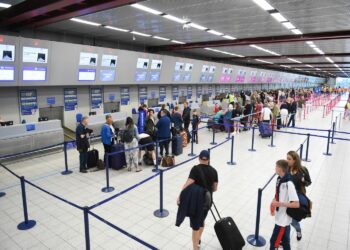 Fancy dress at airport: Image of a busy check-in