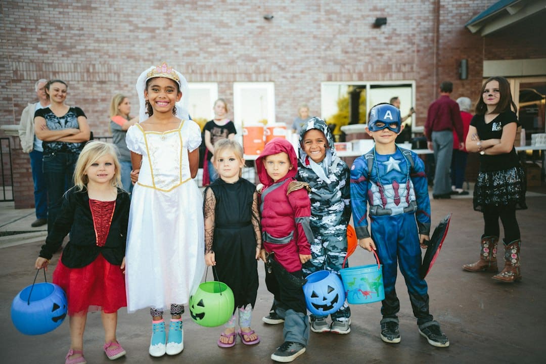Children wearing varied Halloween costumes at an outdoor gathering