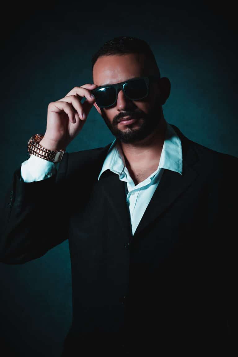 Man wearing a black suit and sunglasses