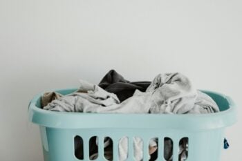 Laundry basket filled with light and dark clothes