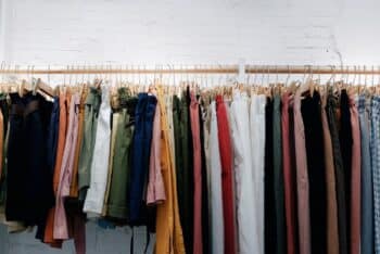 Clothing organised on a rail against a white wall