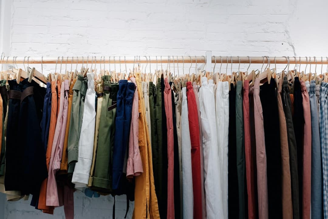 Clothing organised on a rail against a white wall