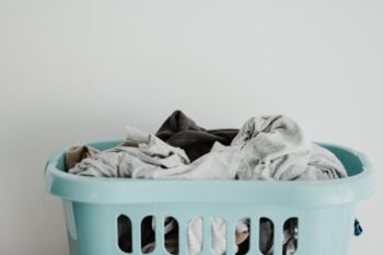 Clothes in a pale green laundry basket