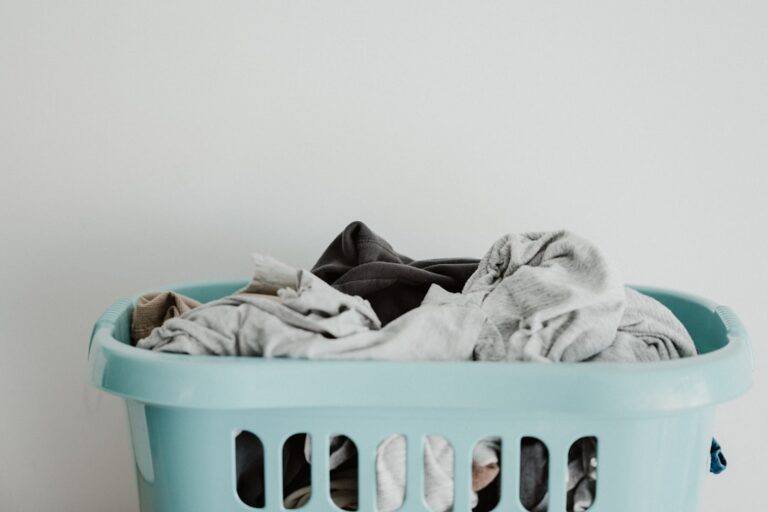 Clothes in a pale green laundry basket