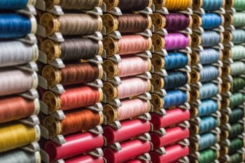 Rows of colourful sewing thread spools